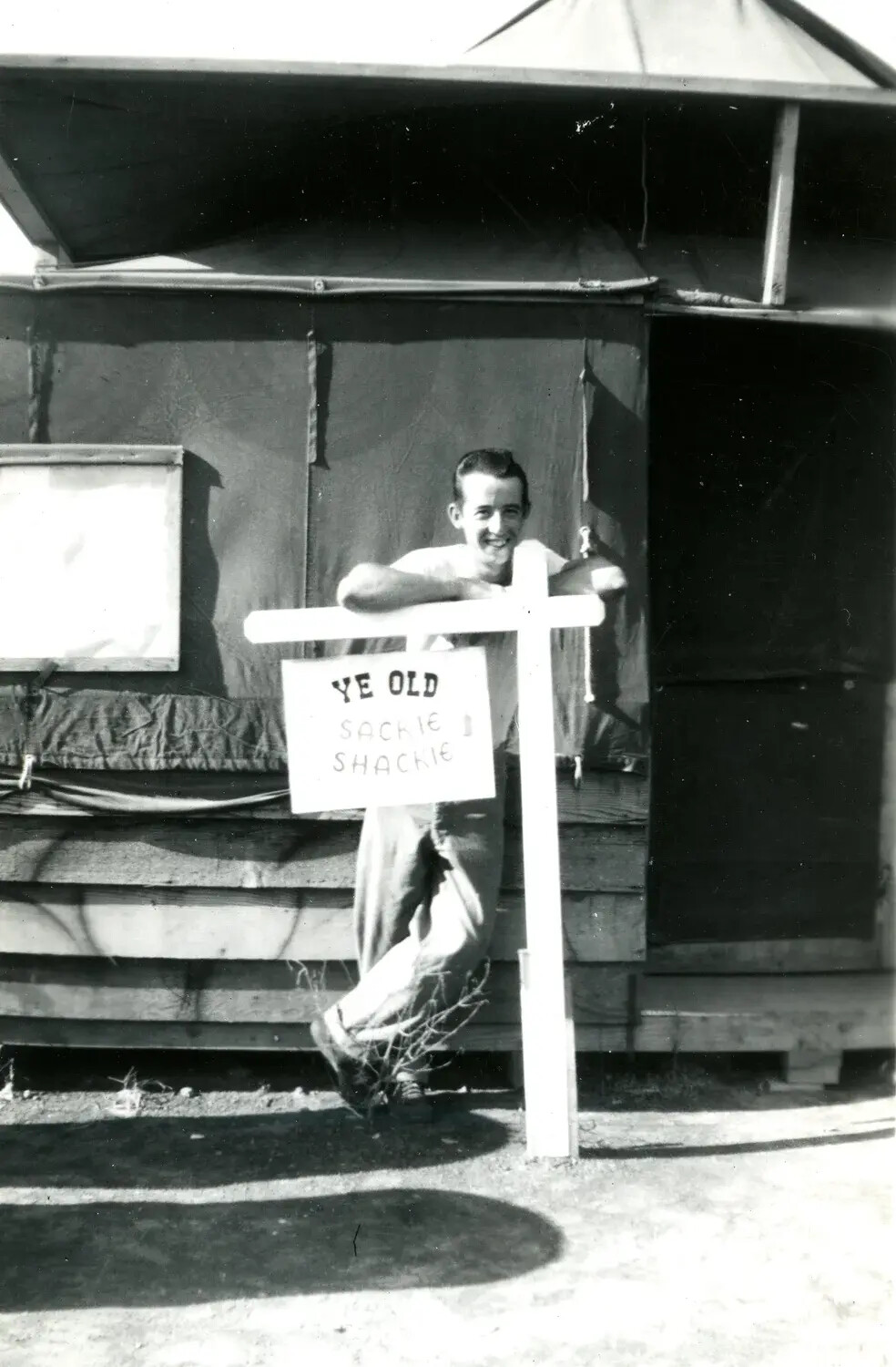 Marine at "Ye Old Sackie Shackie" Camp Sign