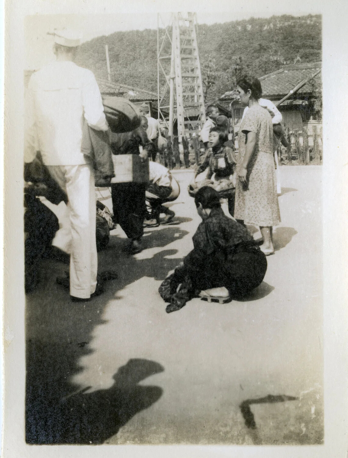 Japanese Civilians and US Sailor at Village Gathering Point, Occupied Japan, circa 1945-1946