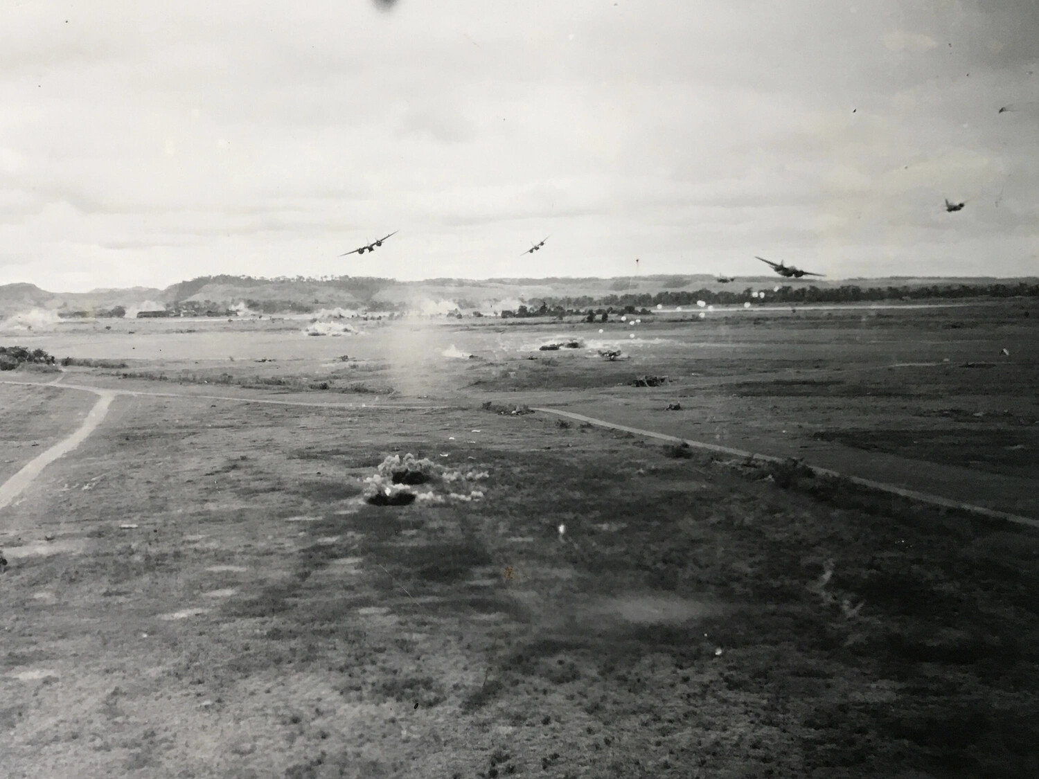 B-25 Mitchells Pulling Off Target During a Low-Altitude Attack, Bomb Craters Visible Below