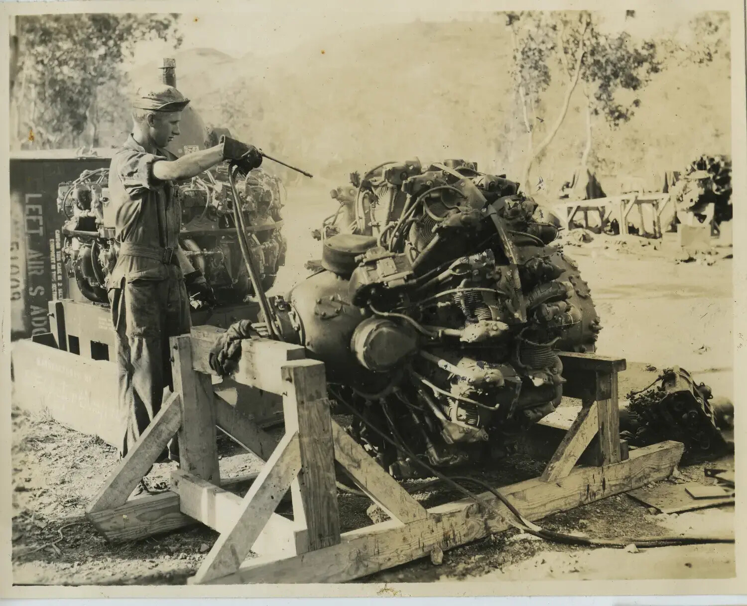Ground Crewman Servicing R-2600 Radial Engine on Field Maintenance Stand