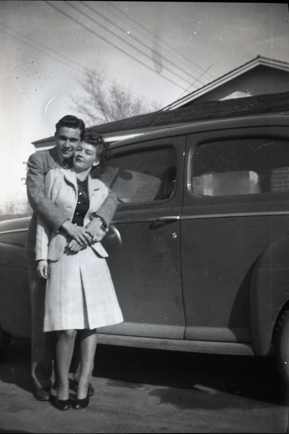 Couple Embracing Beside Sedan, Kelley Family Album
