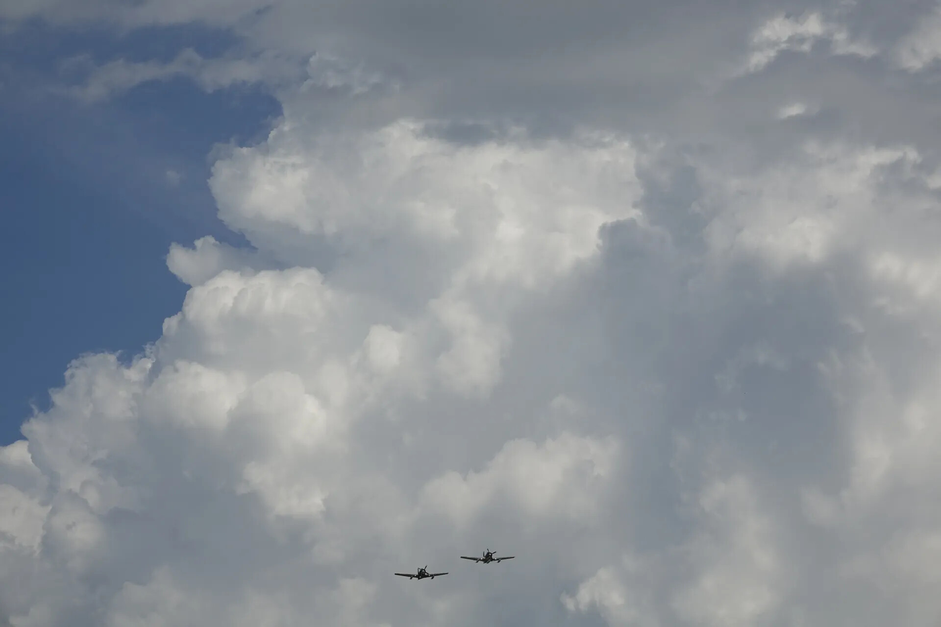 Two Aircraft in Formation Flight Against Cumulus Clouds, May 2019 Reunion Event