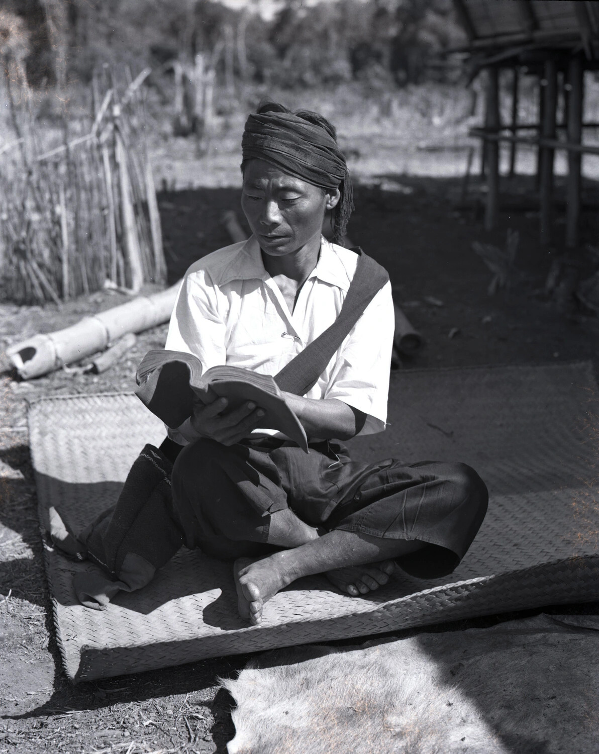 Village Man Reading a Book, Burma, WWII China-Burma-India Theater Collection