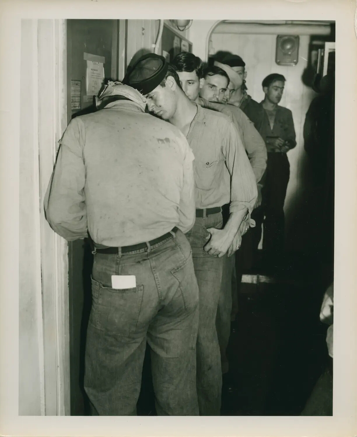Sailors Queued in Passageway Aboard USS Petrof Bay (CVE-80), World War II