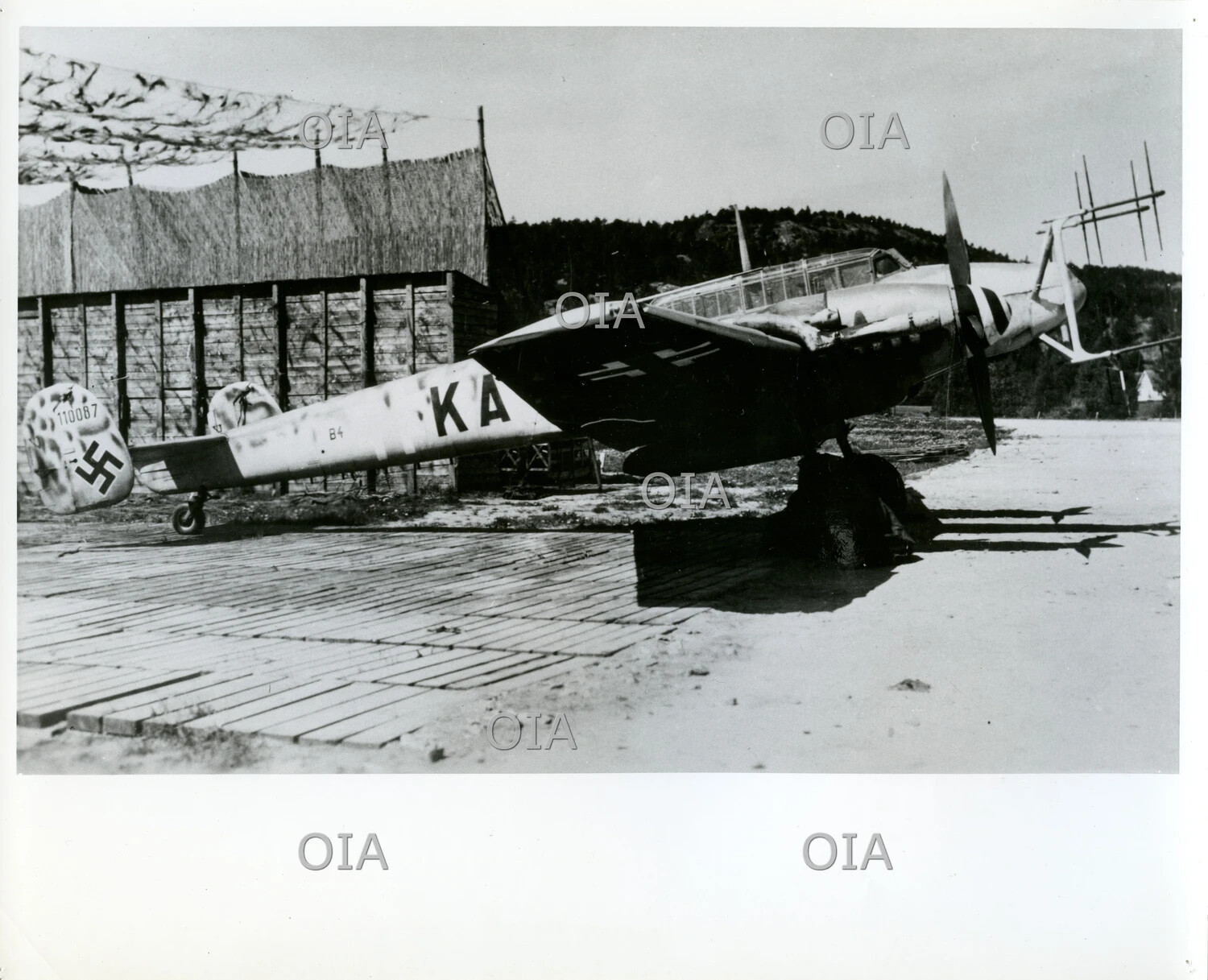 Captured German Messerschmitt Bf 108 'Taifun' Liaison Aircraft at a Camouflaged Airfield, WWII