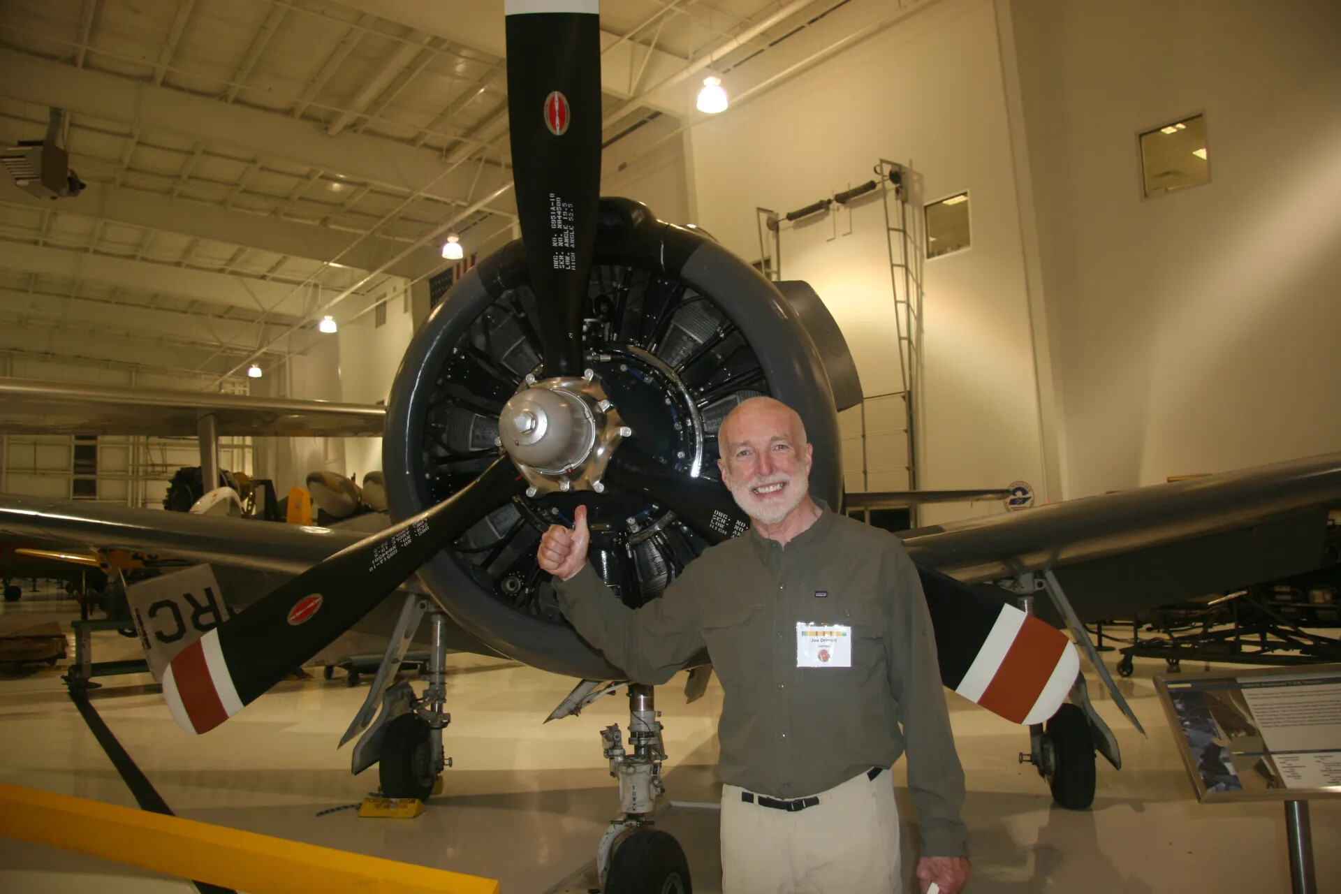 Reunion Attendee Poses with Vintage Radial Engine Aircraft, 2016 Operation Tailwind Reunion