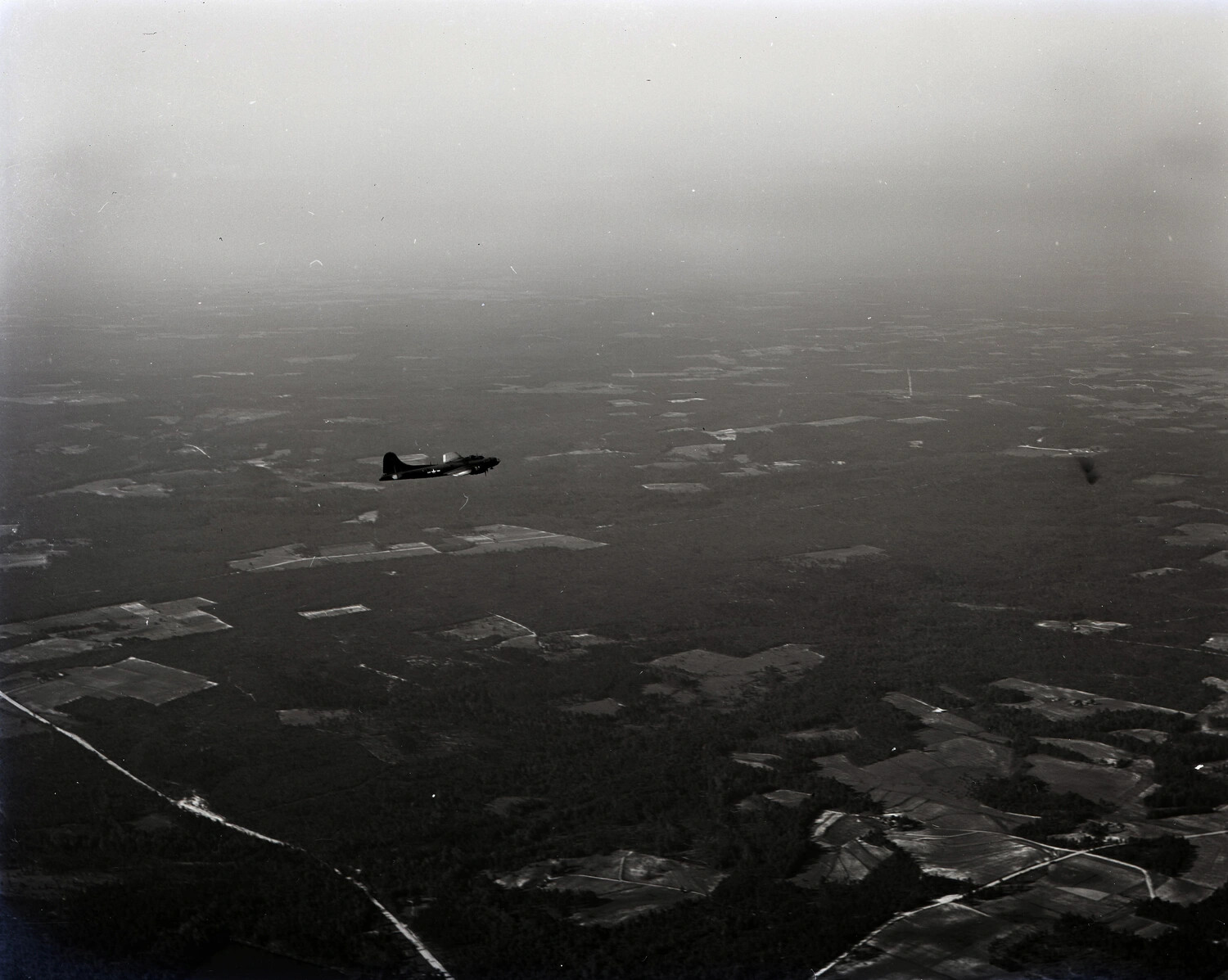 Air-to-Air Photograph of B-17 Flying Fortress in Flight Over Farmland