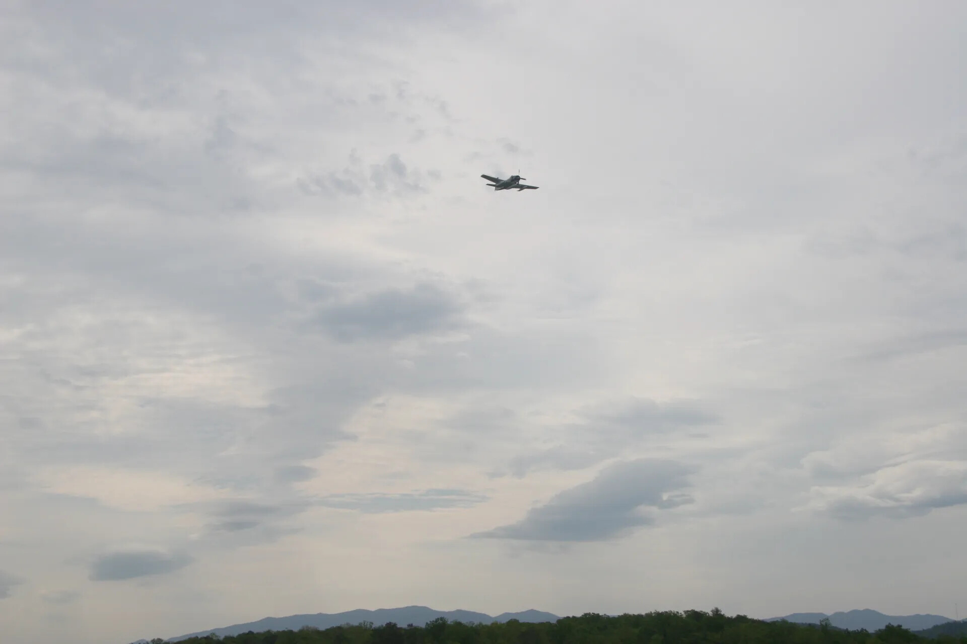 Skyraider Aircraft in Flight During Airshow Flyover, Overcast Sky