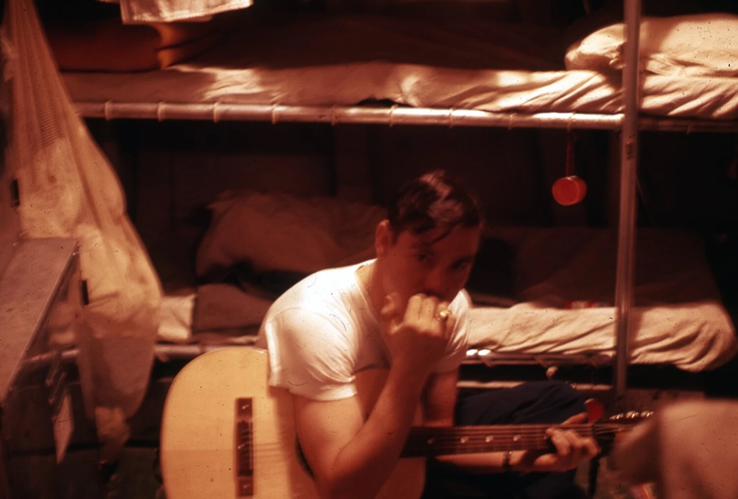 Sailor Playing Guitar and Harmonica in Berthing Compartment, USS Ticonderoga, Vietnam War Era