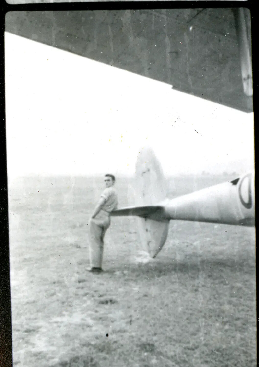Serviceman Leaning on Aircraft Tail Section, CBI Theater, WWII