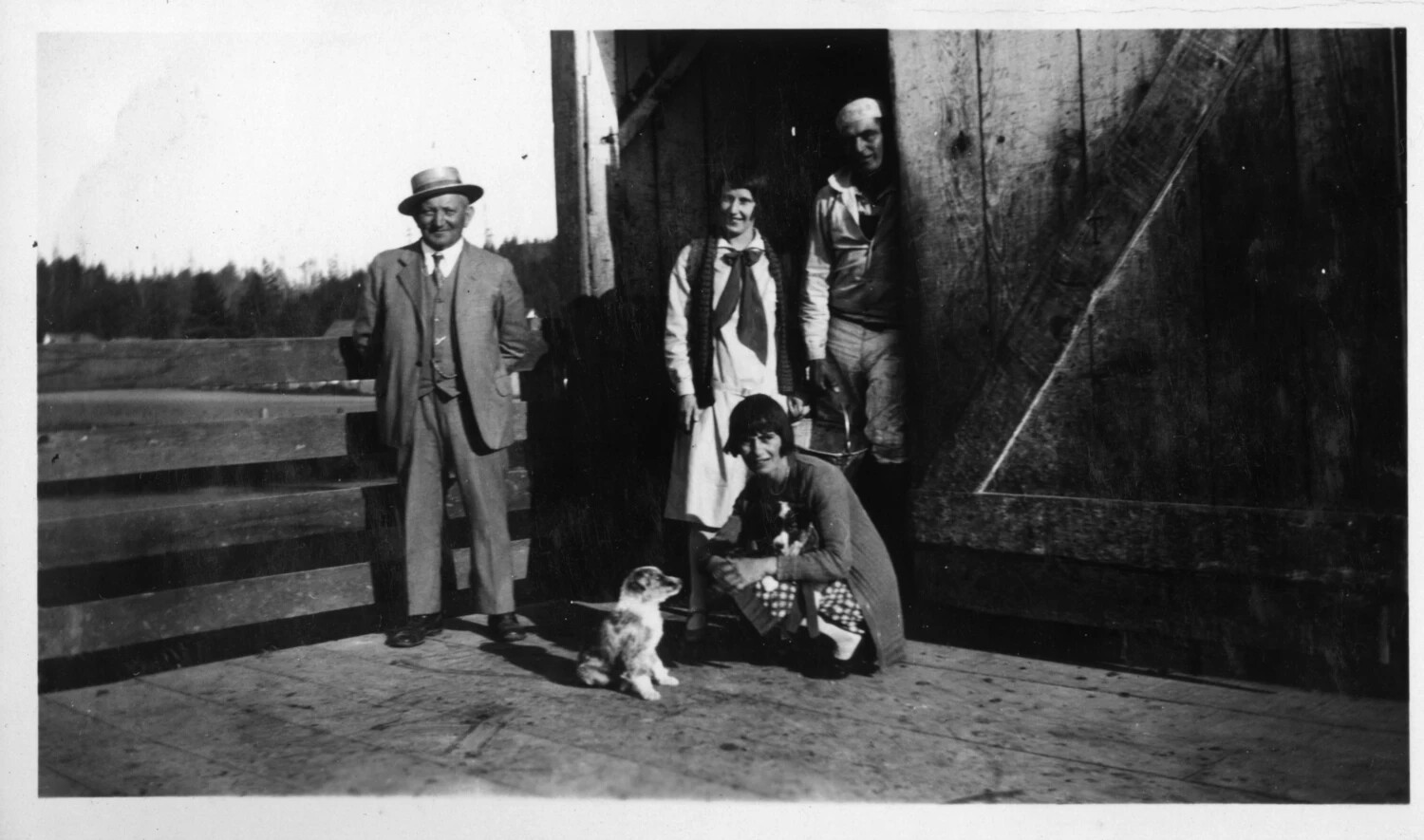 Family Group at a Barn Doorway with Puppies, circa 1920-1928