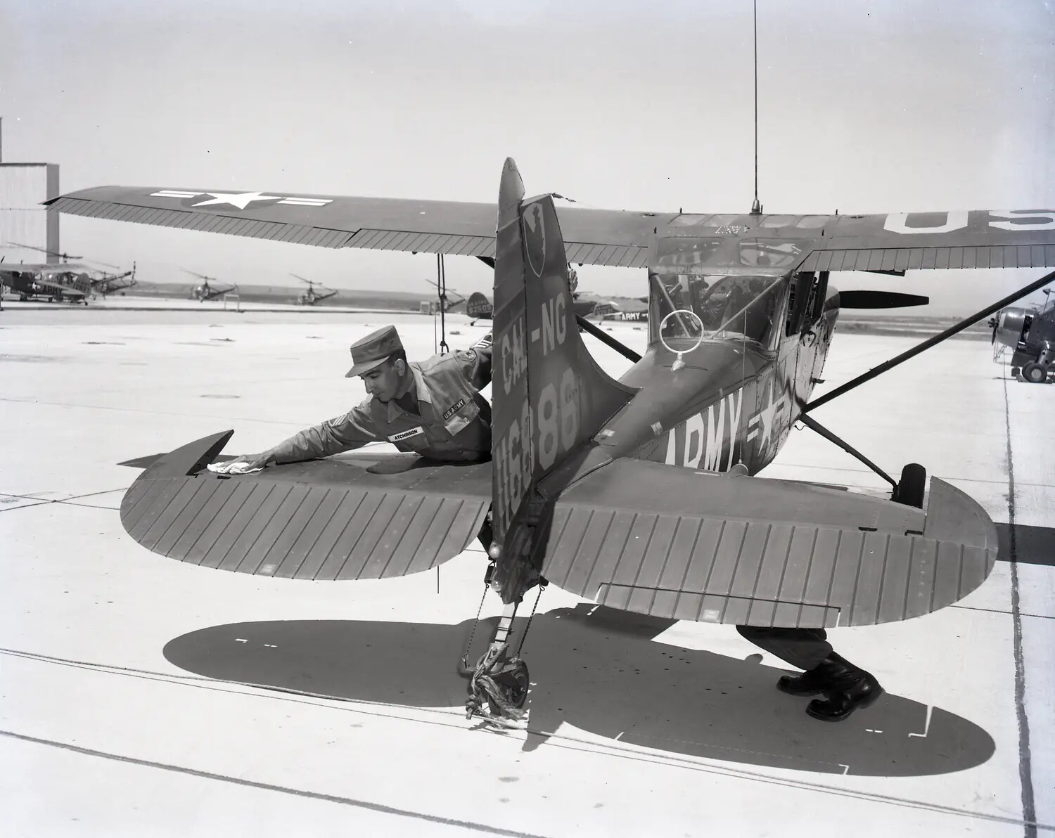 California Army National Guard Soldier Cleaning a Cessna L-19 Bird Dog, Sacramento, 1960