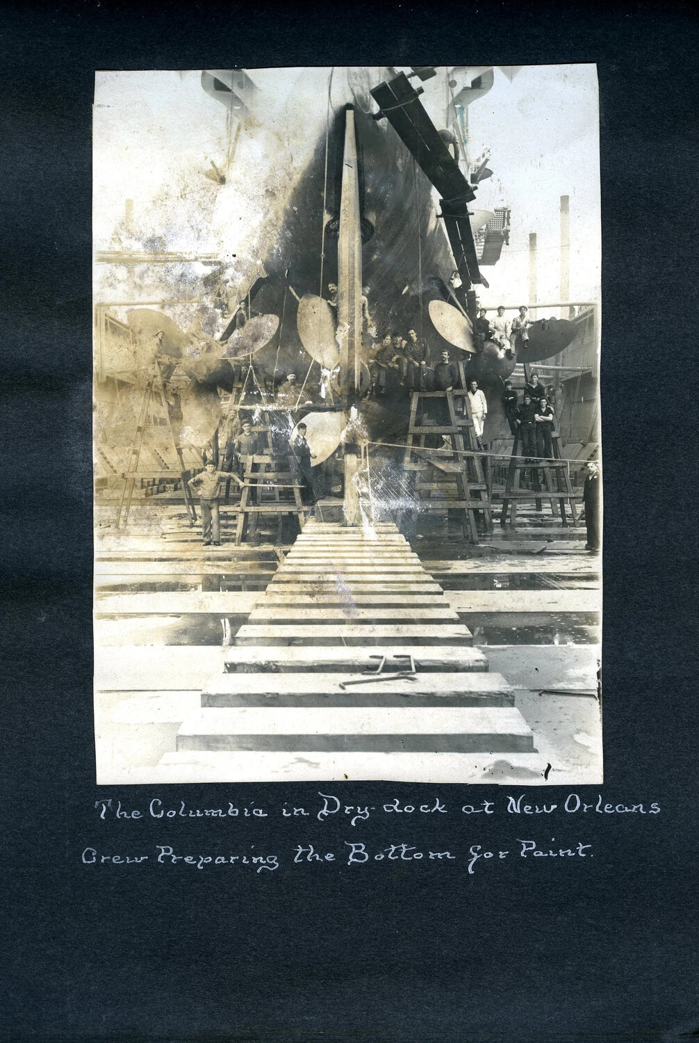USS Columbia in Dry Dock at New Orleans, Crew Preparing the Hull for Paint