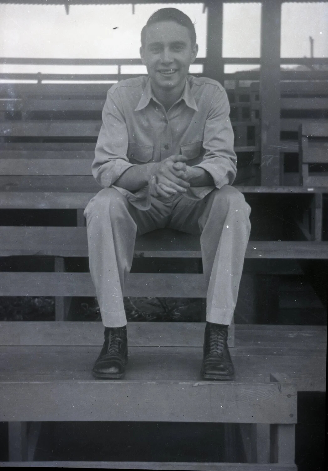 Portrait of a Serviceman Seated on Wooden Bleachers, Jack T. Kelley Album