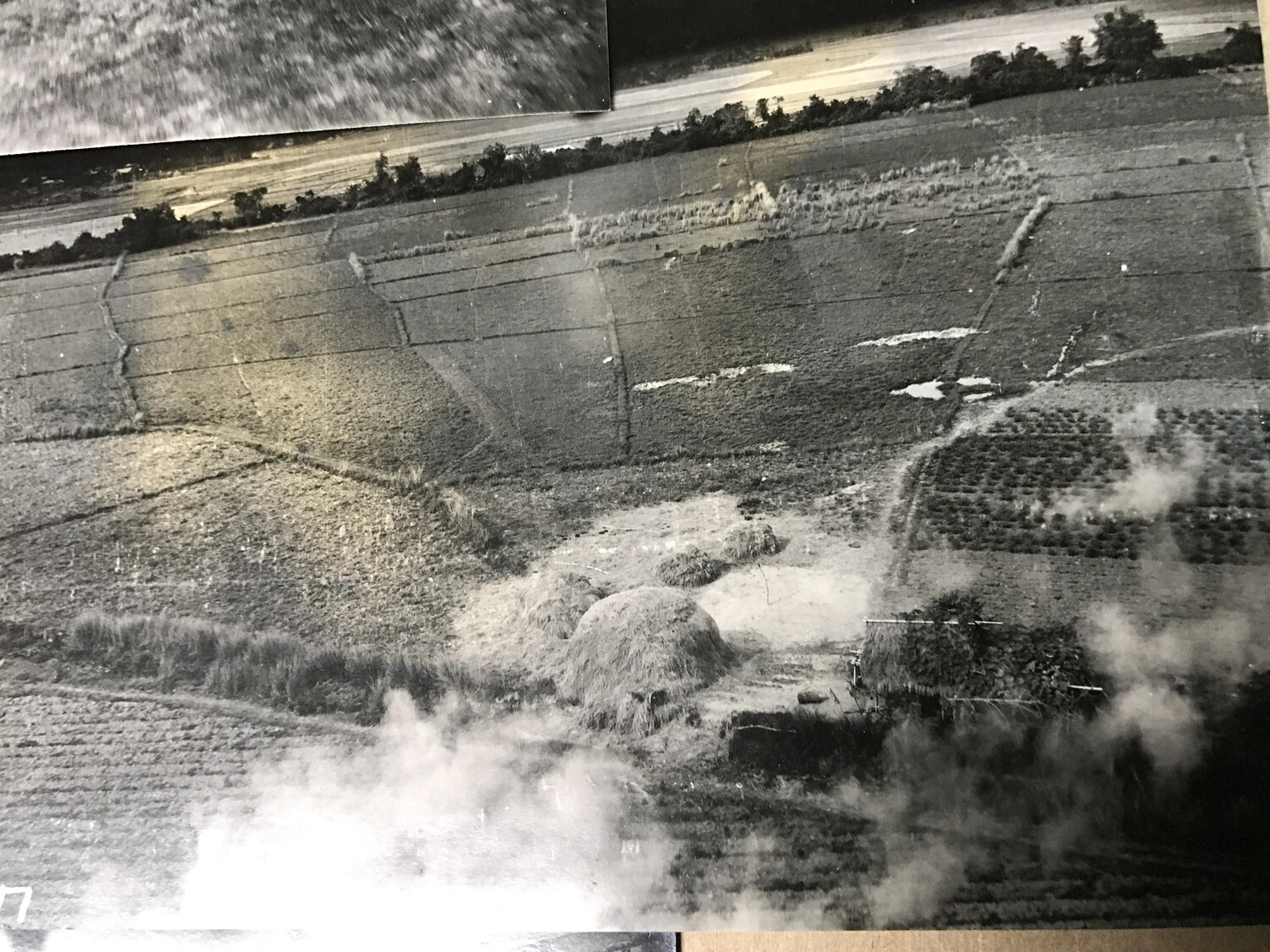 Album Print: Wide View of Cultivated Fields and Haystacks with Attack Smoke, Partial Negative Number