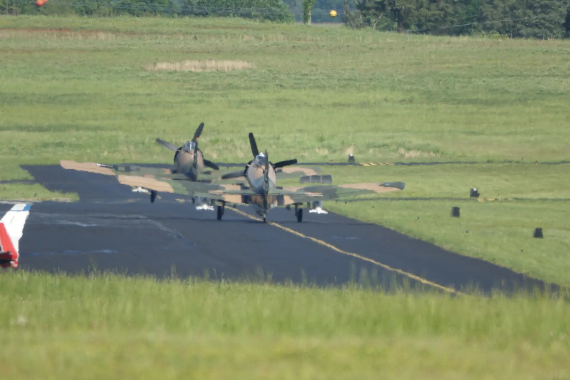 Two Camouflaged Douglas A-1 Skyraiders on Runway, May 2019 Reunion Event