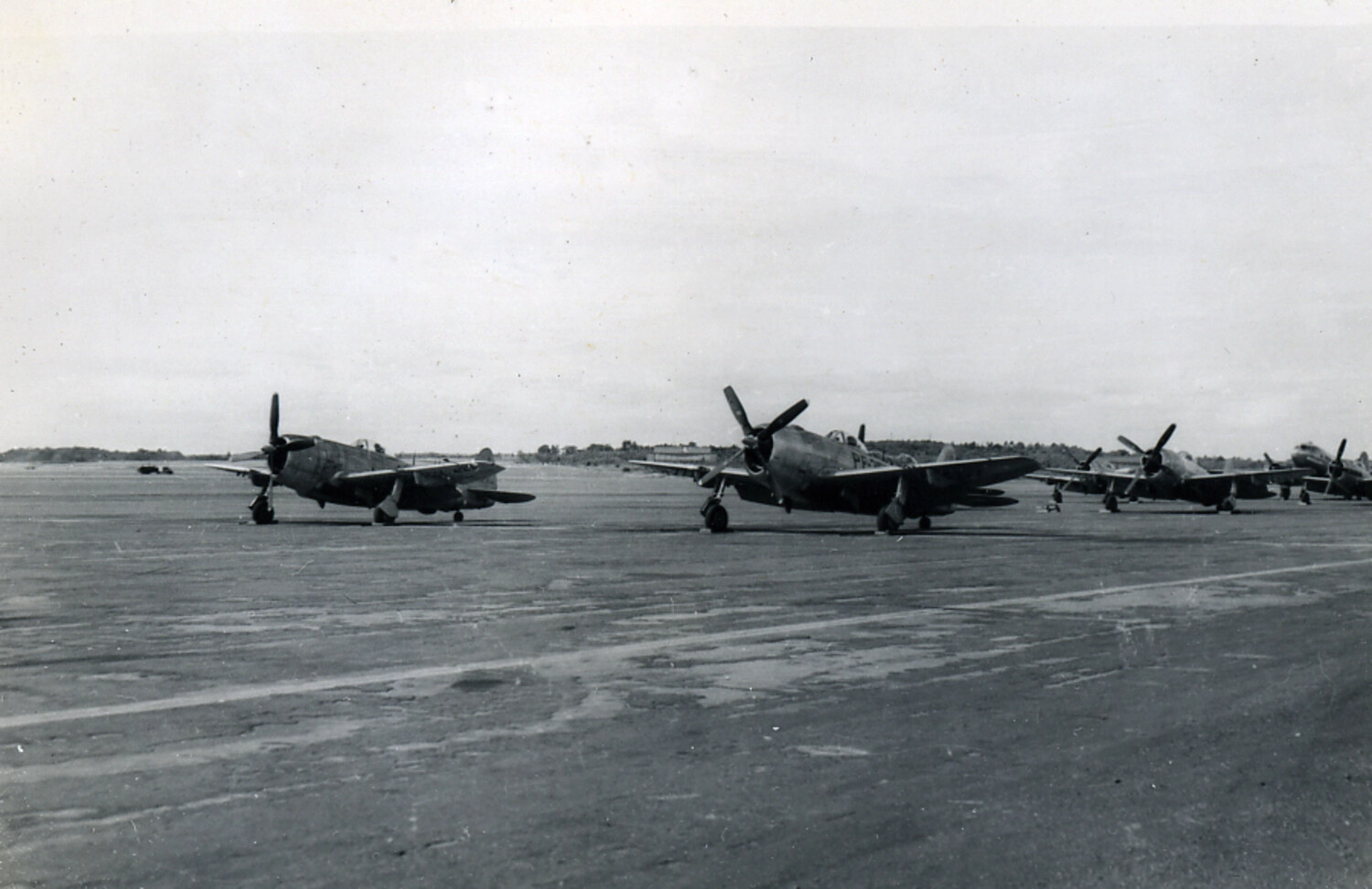 Row of P-47 Thunderbolt Fighters on Airfield Ramp, Postwar Japan