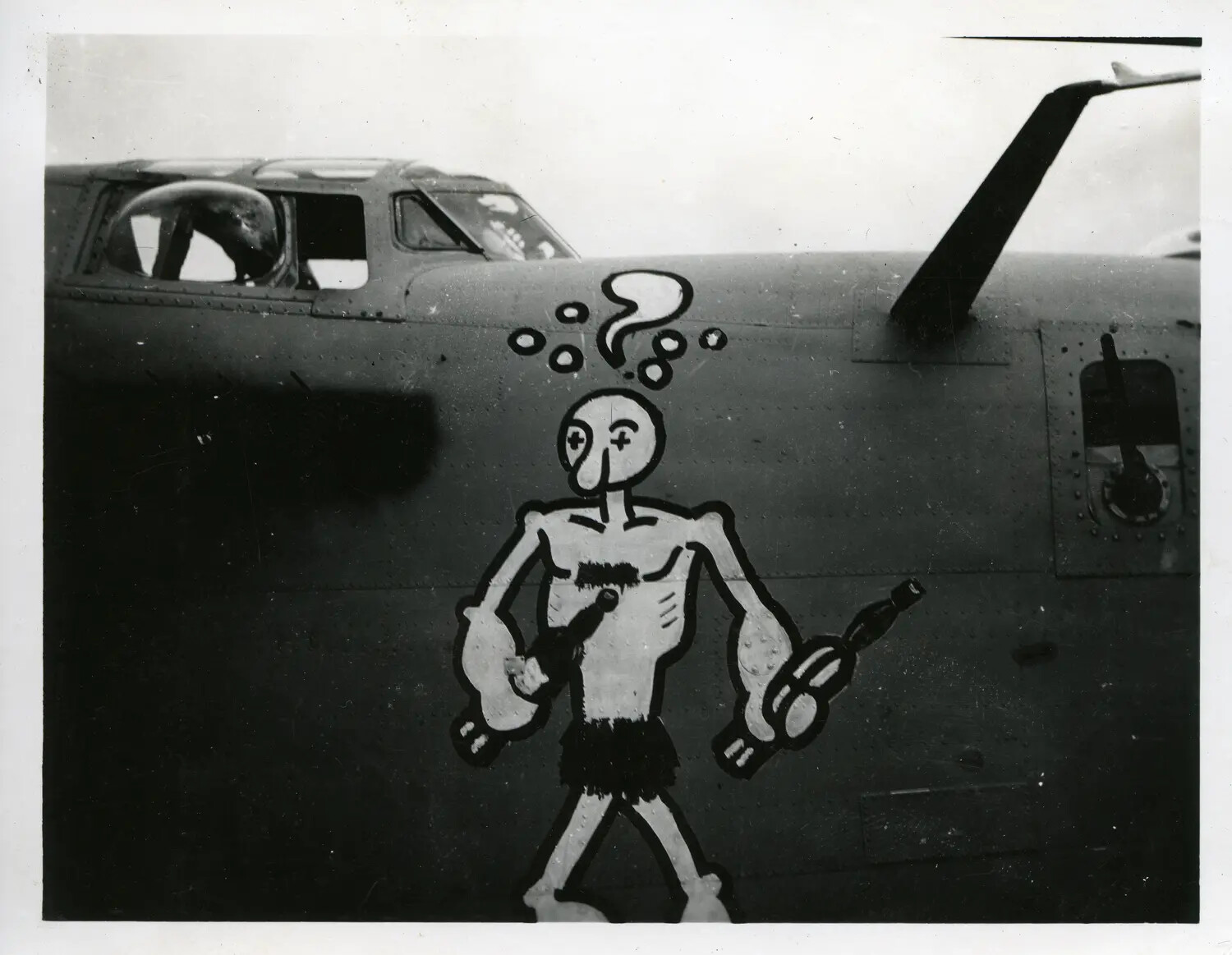 Cartoon Nose Art — Dazed Figure with Question Mark, B-24 Liberator (likely), WWII Pacific Theater