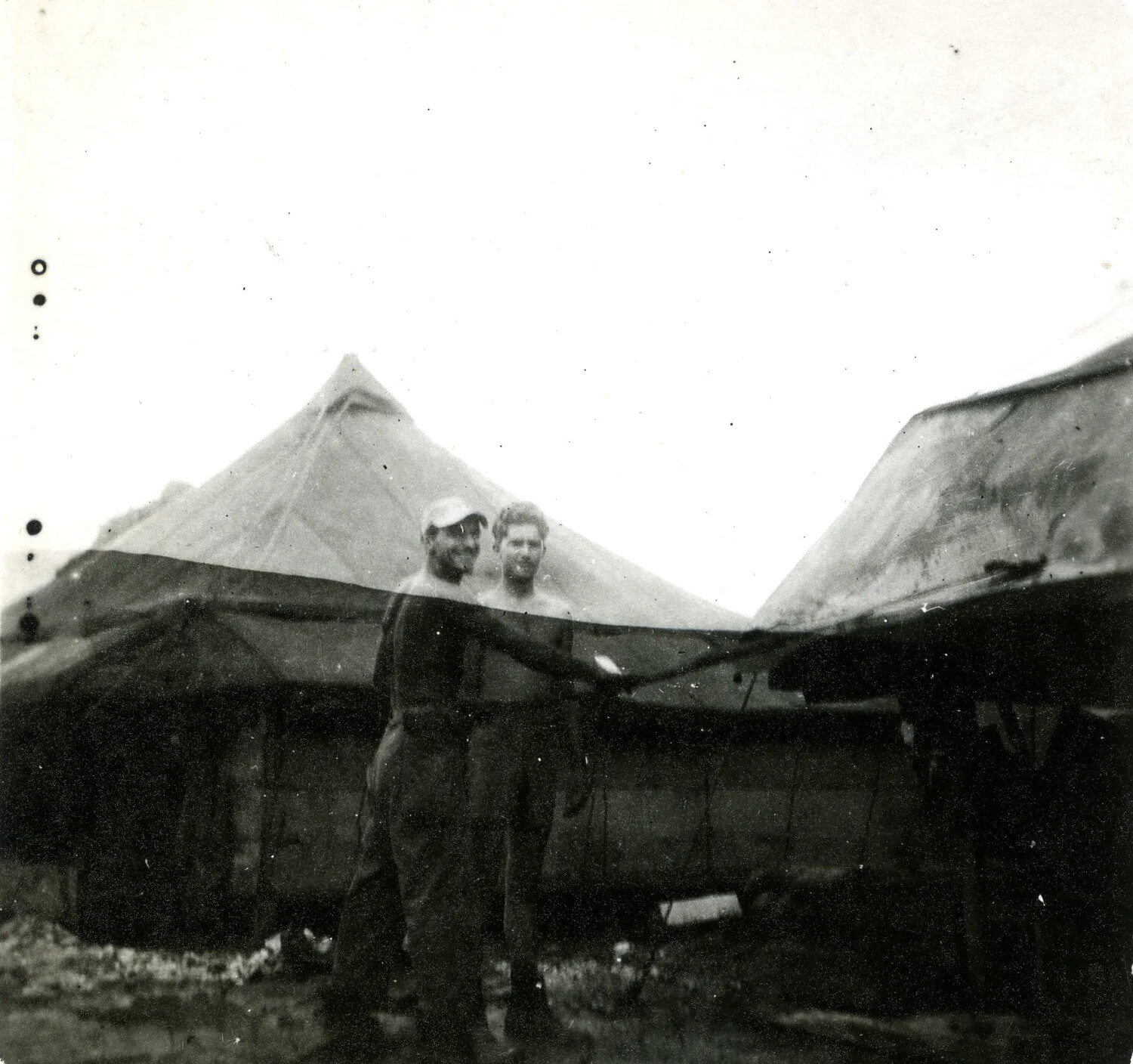 Two Servicemen Before Squad Tents, 345th Bombardment Group Encampment, Pacific Theater, WWII (Damaged Negative)