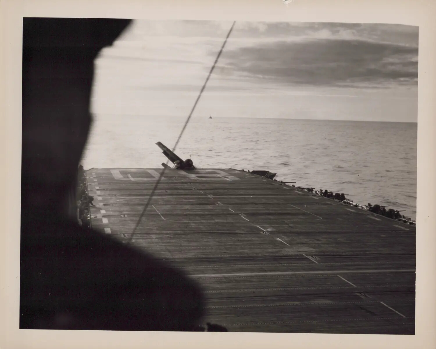 Aircraft Tipped Over the Round-Down of an Escort Carrier Flight Deck, WWII