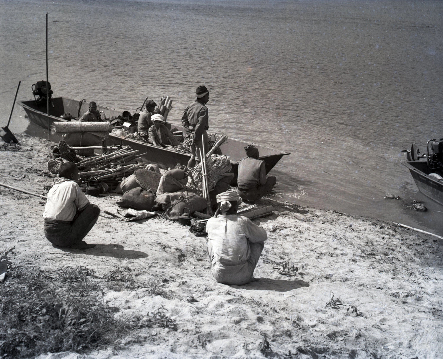 Riverbank Loading Scene with Local Boatmen and Motorized Sampans, China-Burma-India Theater, WWII