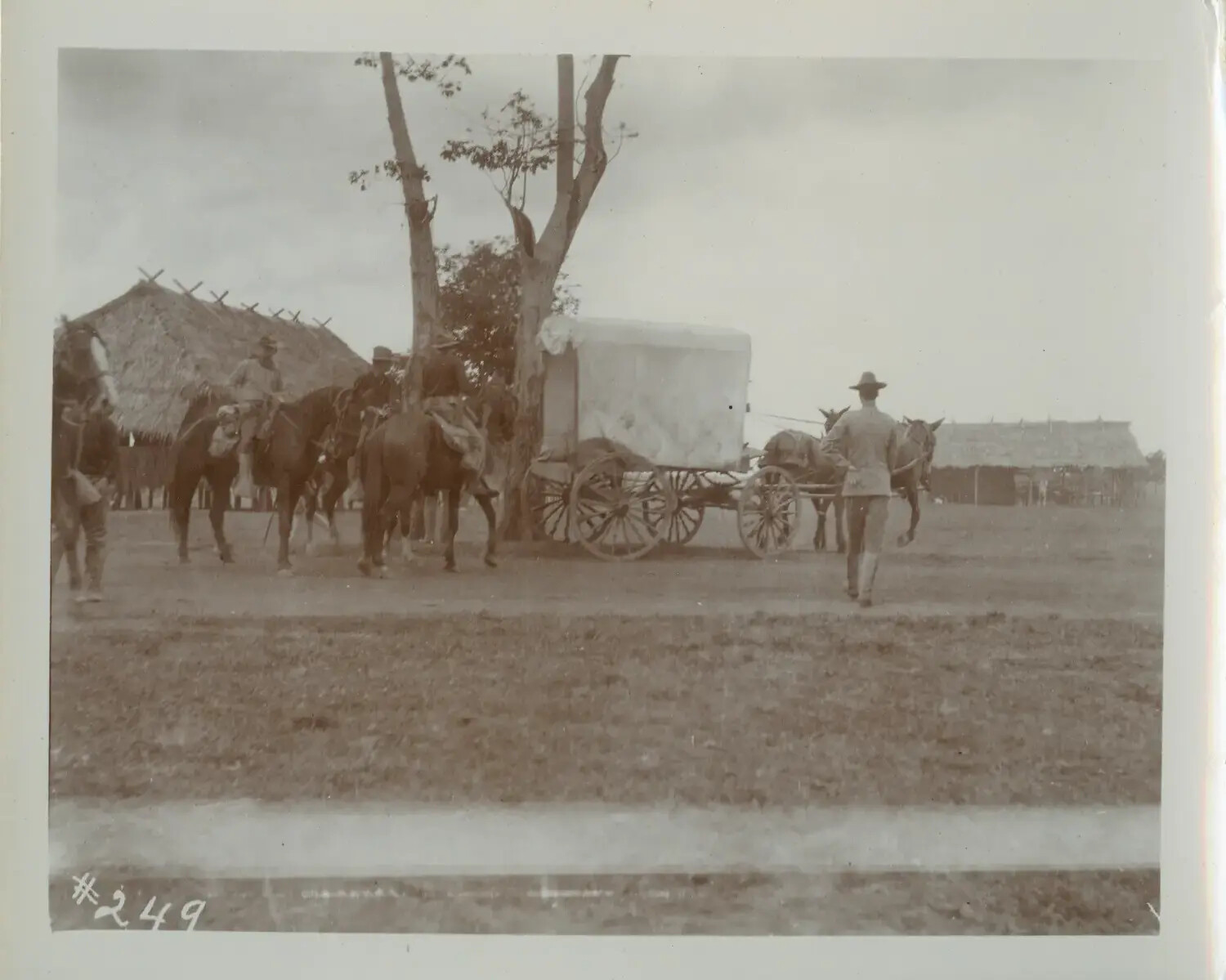 U.S. Army Soldiers, Horses, and Covered Supply Wagon Near a Philippine Barrio, Philippine-American War Era (c. 1898-1902)