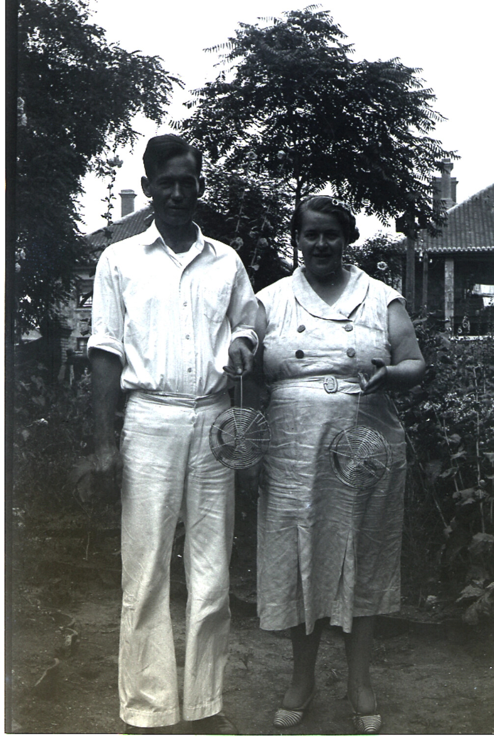 Couple Posing with Wire Fly Swatters in a Garden, Mid-1930s