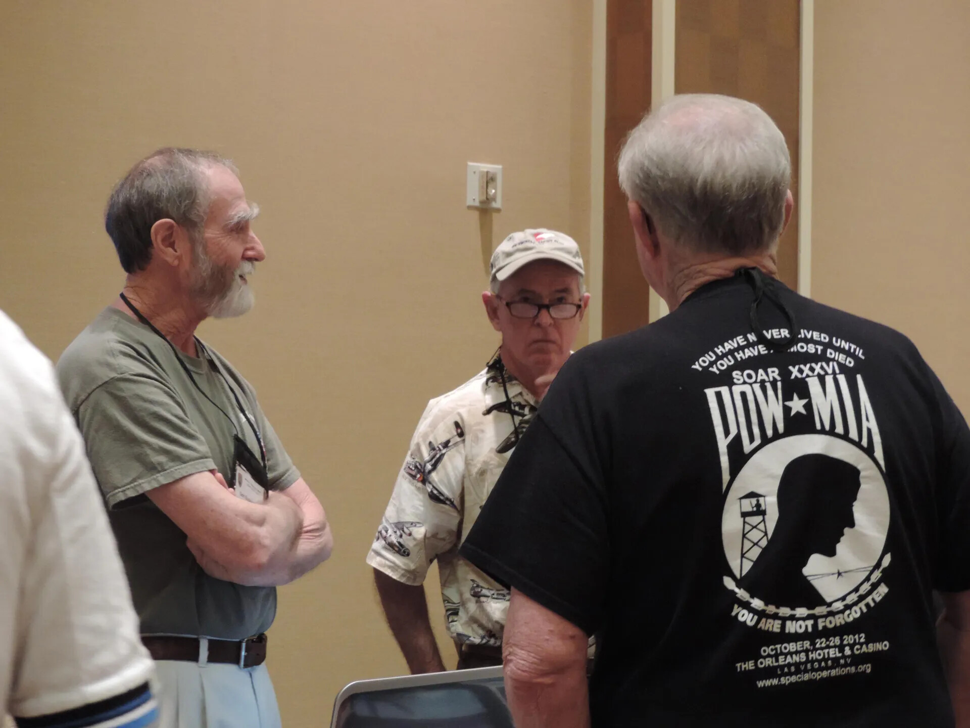 Members in Conversation, One Wearing a SOAR XXXVI POW/MIA Souvenir Shirt (The Orleans Hotel & Casino, October 2012), Photographed at the 2013 Reunion