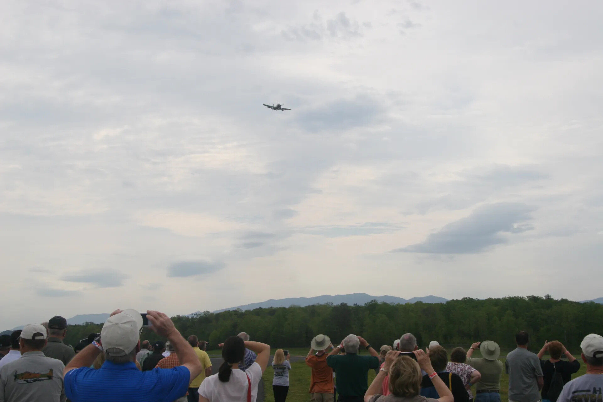 Spectators Watch a Vintage A-1 Skyraider Flyover at an Operation Tailwind Commemorative Event, April 2016