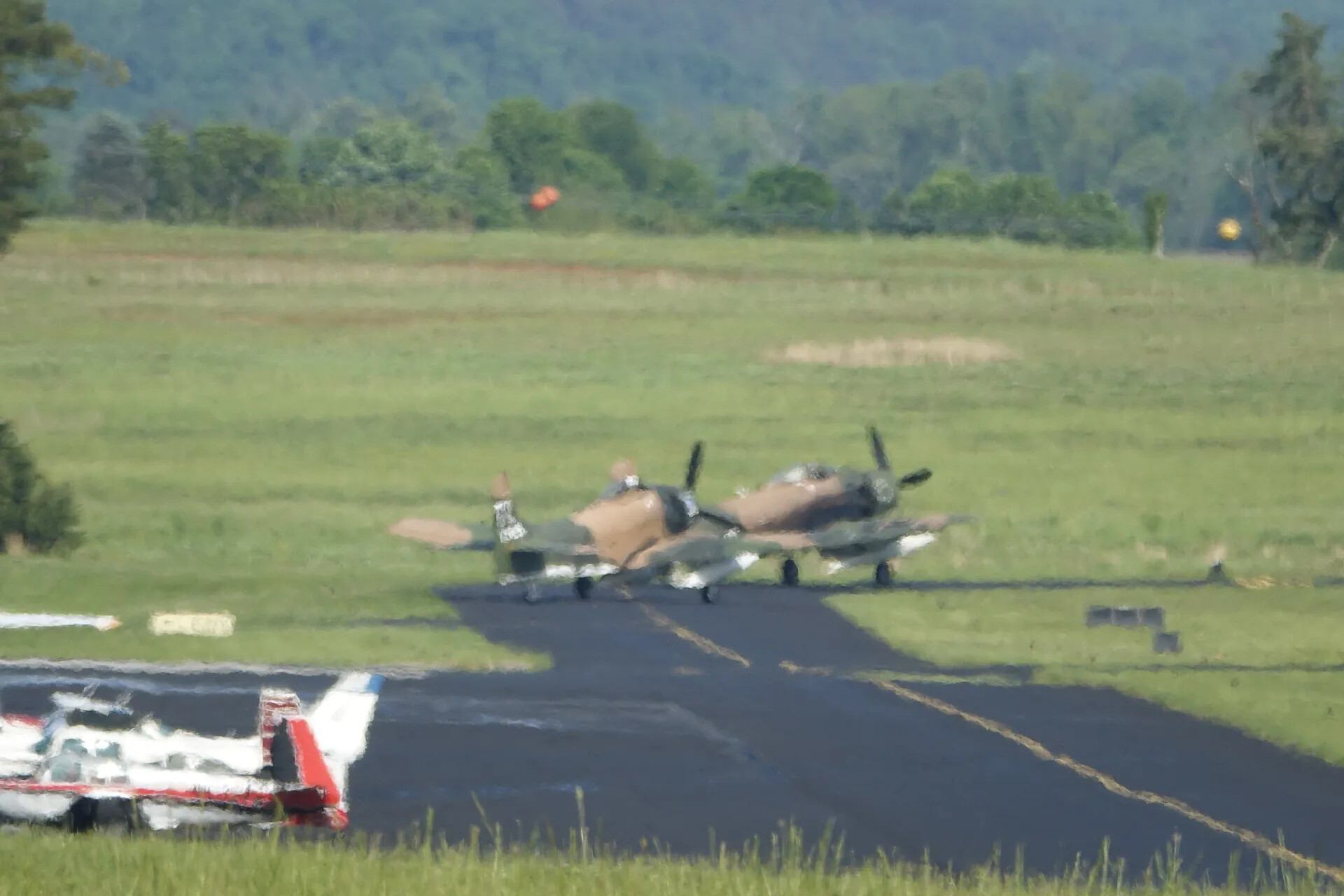 Two Camouflaged A-1 Skyraiders Taxiing at Regional Airport, May 2019