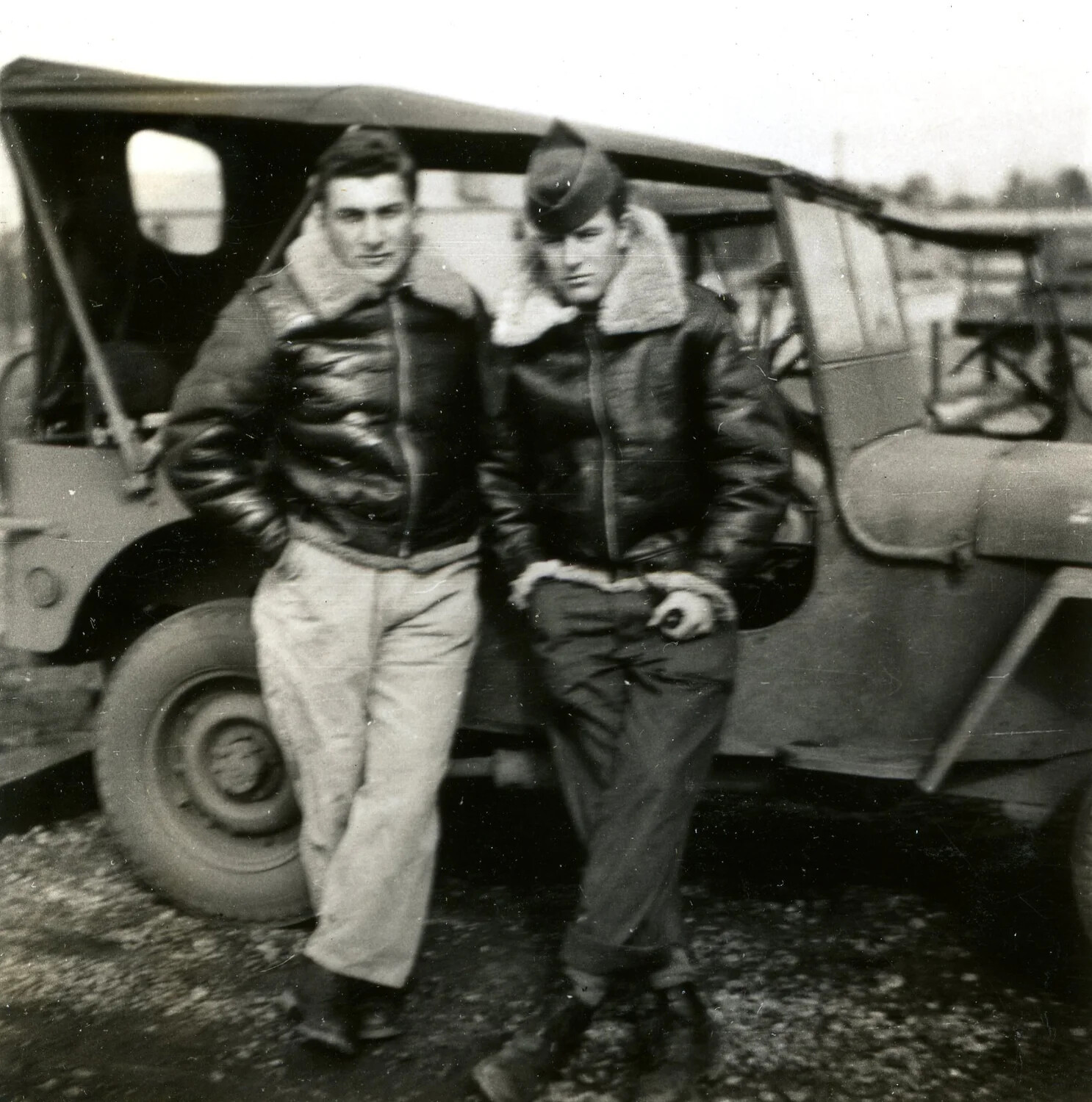 Two Airmen Beside Military Utility Vehicle
