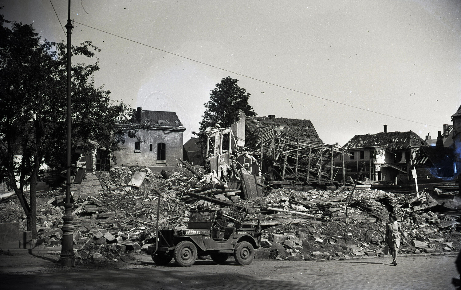 U.S. Army Jeep Passing Bomb-Damaged Buildings, Bremerhaven, Germany, WWII/Postwar Era