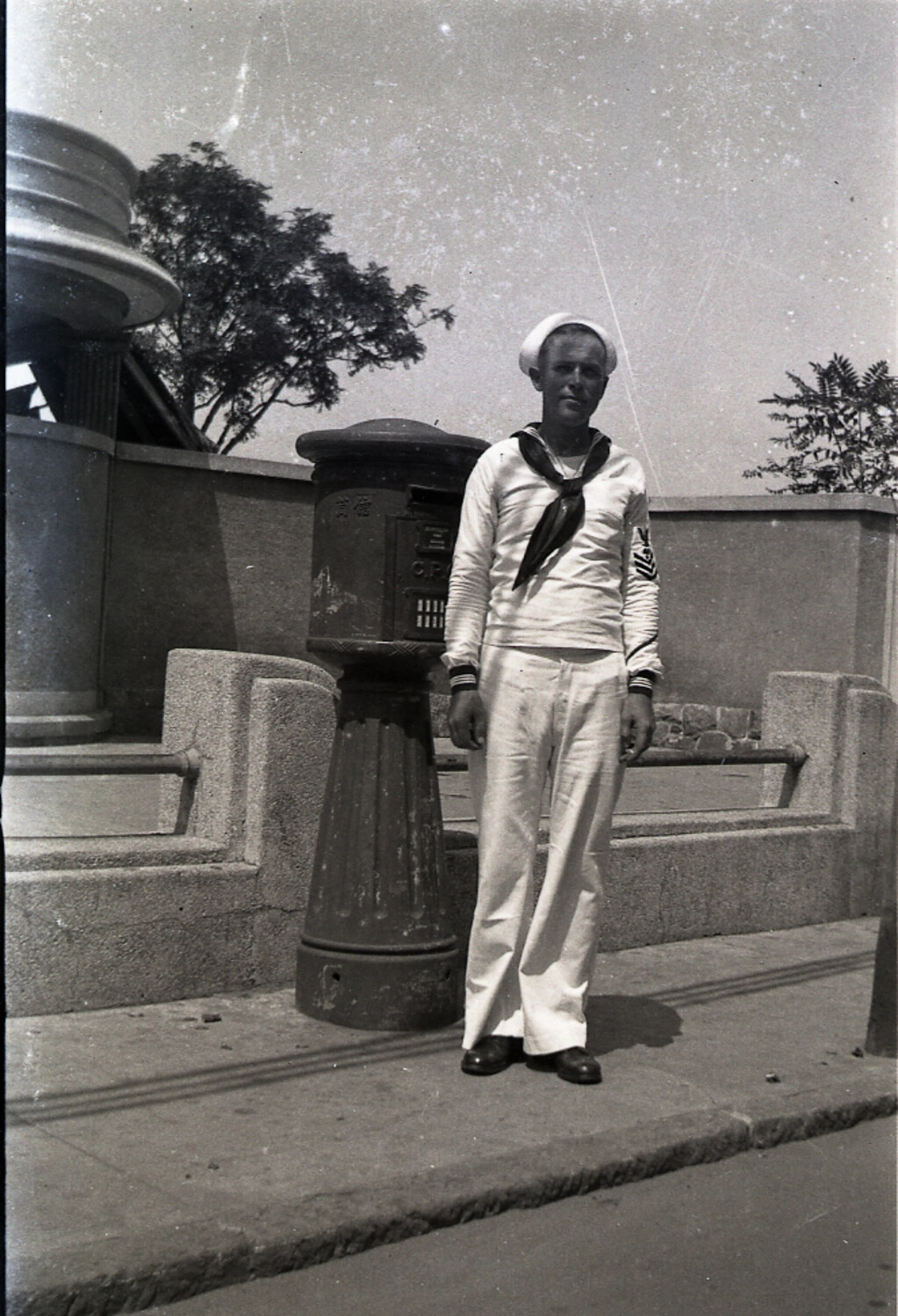 U.S. Navy Sailor Beside a Cast-Iron Postbox, Tsingtao (Qingdao), China