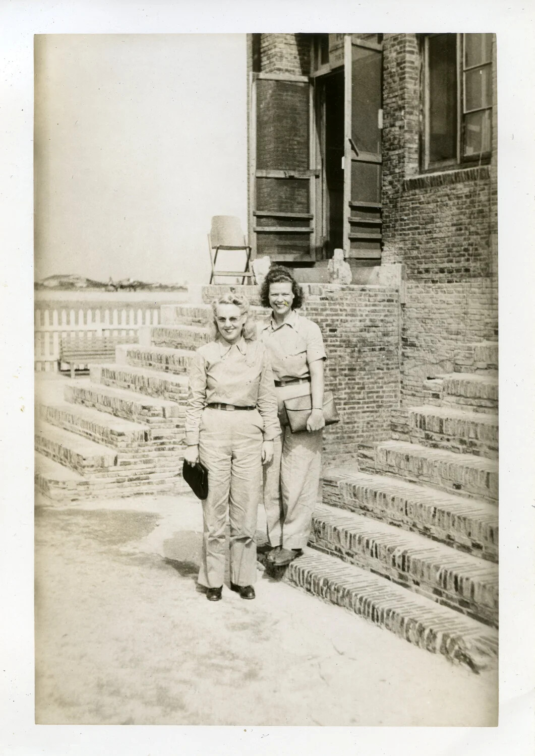 Two Uniformed Women on Brick Steps, Naval Air Transport Squadron VR-6, Agana, Guam