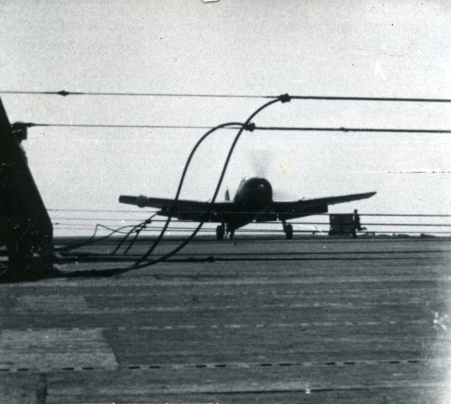 F4U Corsair Behind Crash Barrier Cables on Carrier Flight Deck - VMF-214 Album, 1945