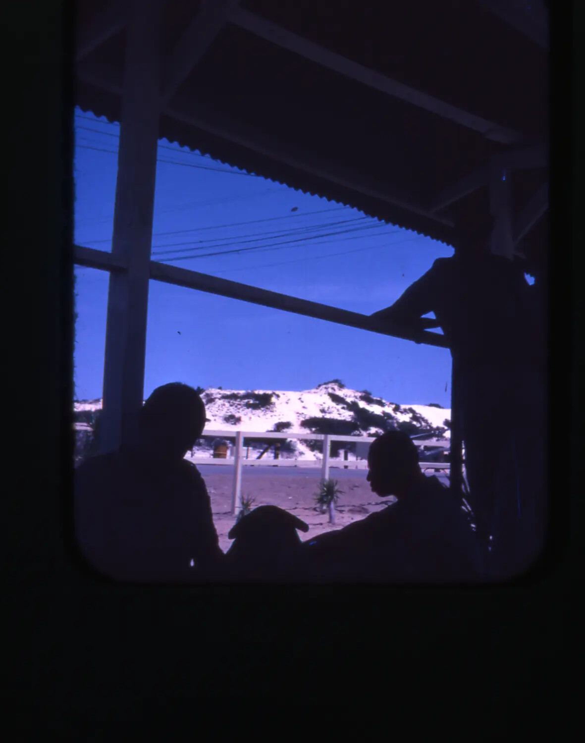 Silhouetted Servicemen on Covered Porch Overlooking Sand Dunes, Cam Ranh Bay, Vietnam