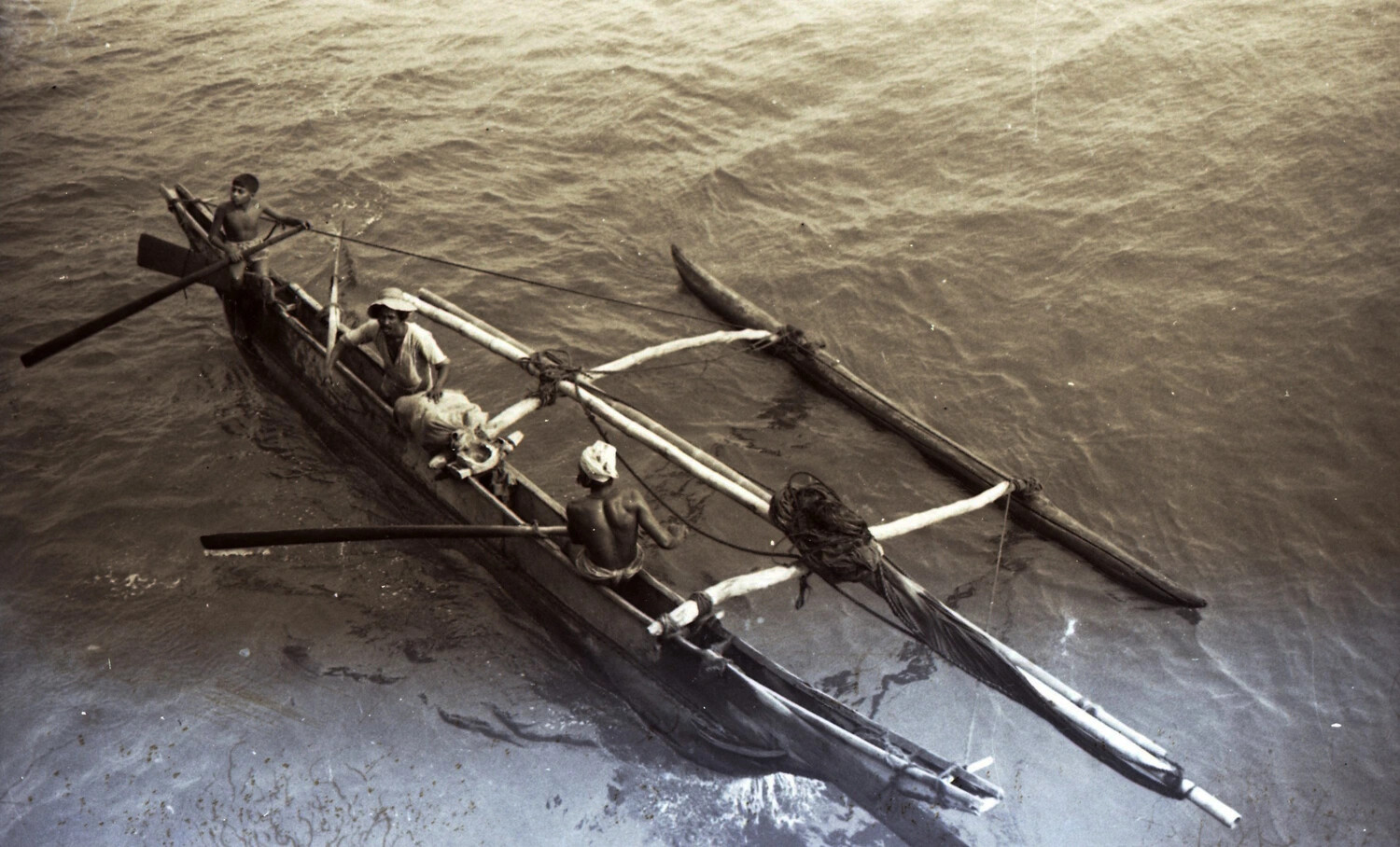 Traditional Outrigger Canoe with Local Watermen, Viewed from Above -- WWII CBI Theater Collection