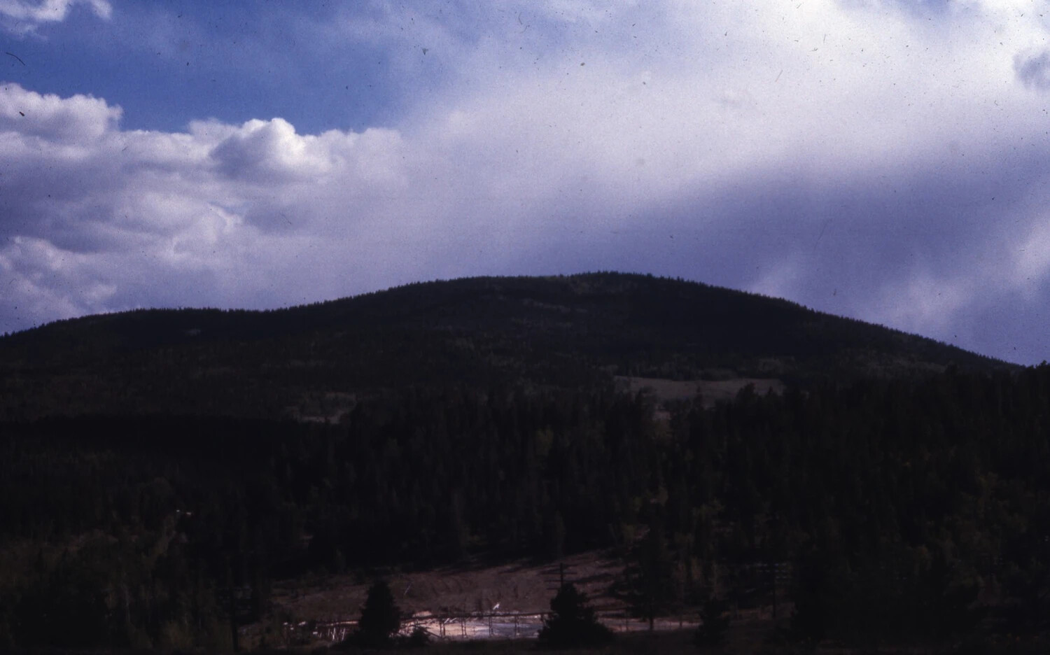 Forested Mountain Ridge Under Storm Clouds, Western Road Trip