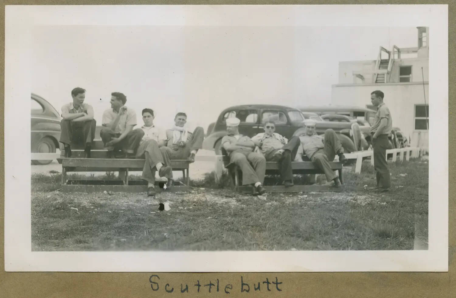 Naval Aviation Cadets and Sailors Trading 'Scuttlebutt' at a Naval Air Station, WWII Era