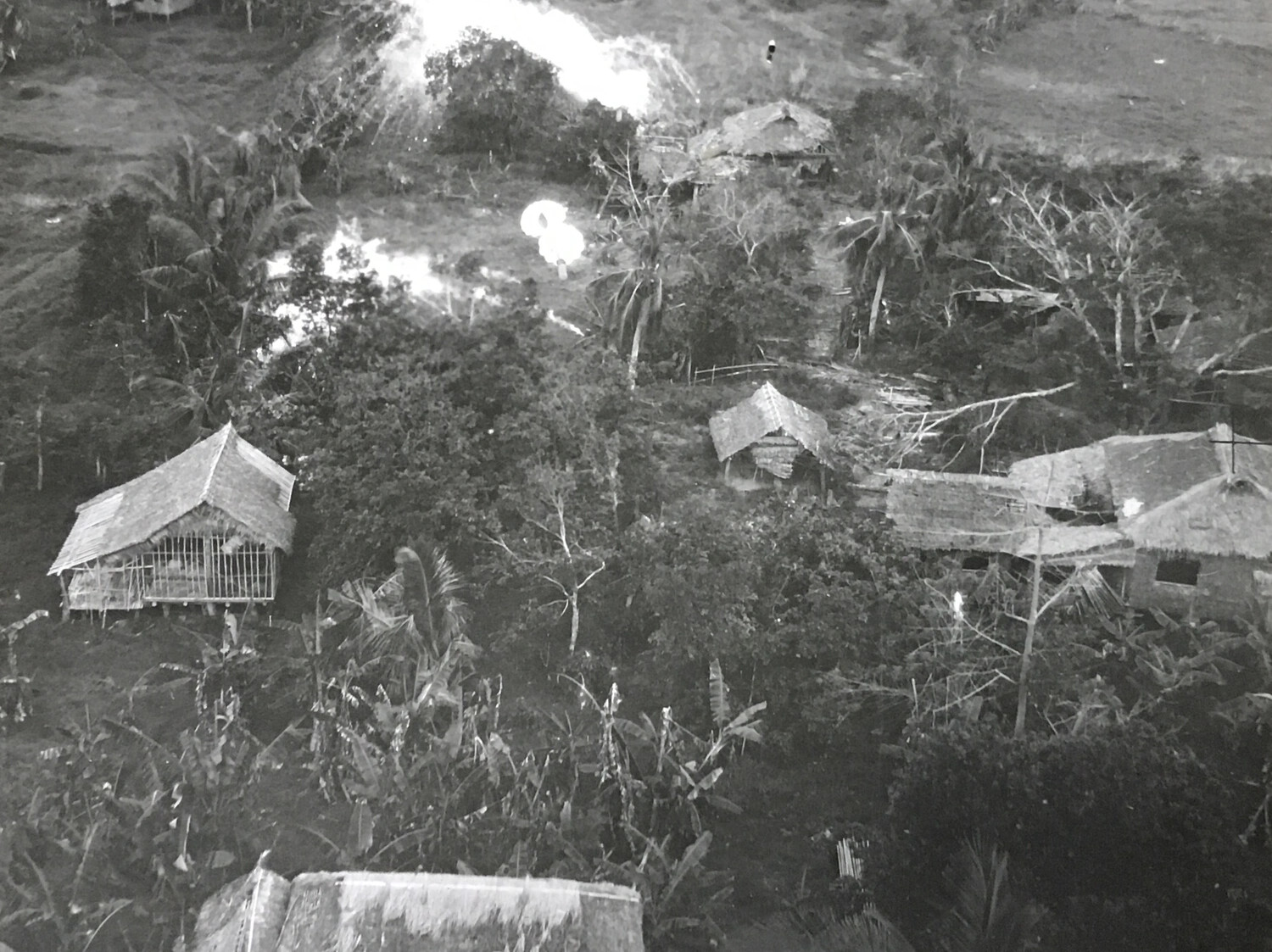 312th Bomb Group Strike Photograph — Parafrag Bomb and Explosion Over Filipino Barrio, Luzon