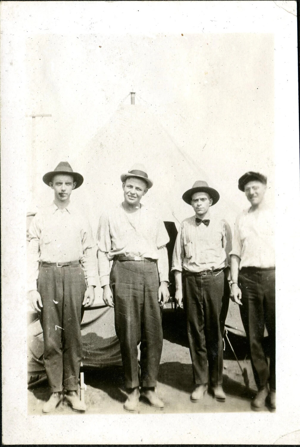 Four Young Men in Civilian Dress Before Tent, WWI-Era Training Camp