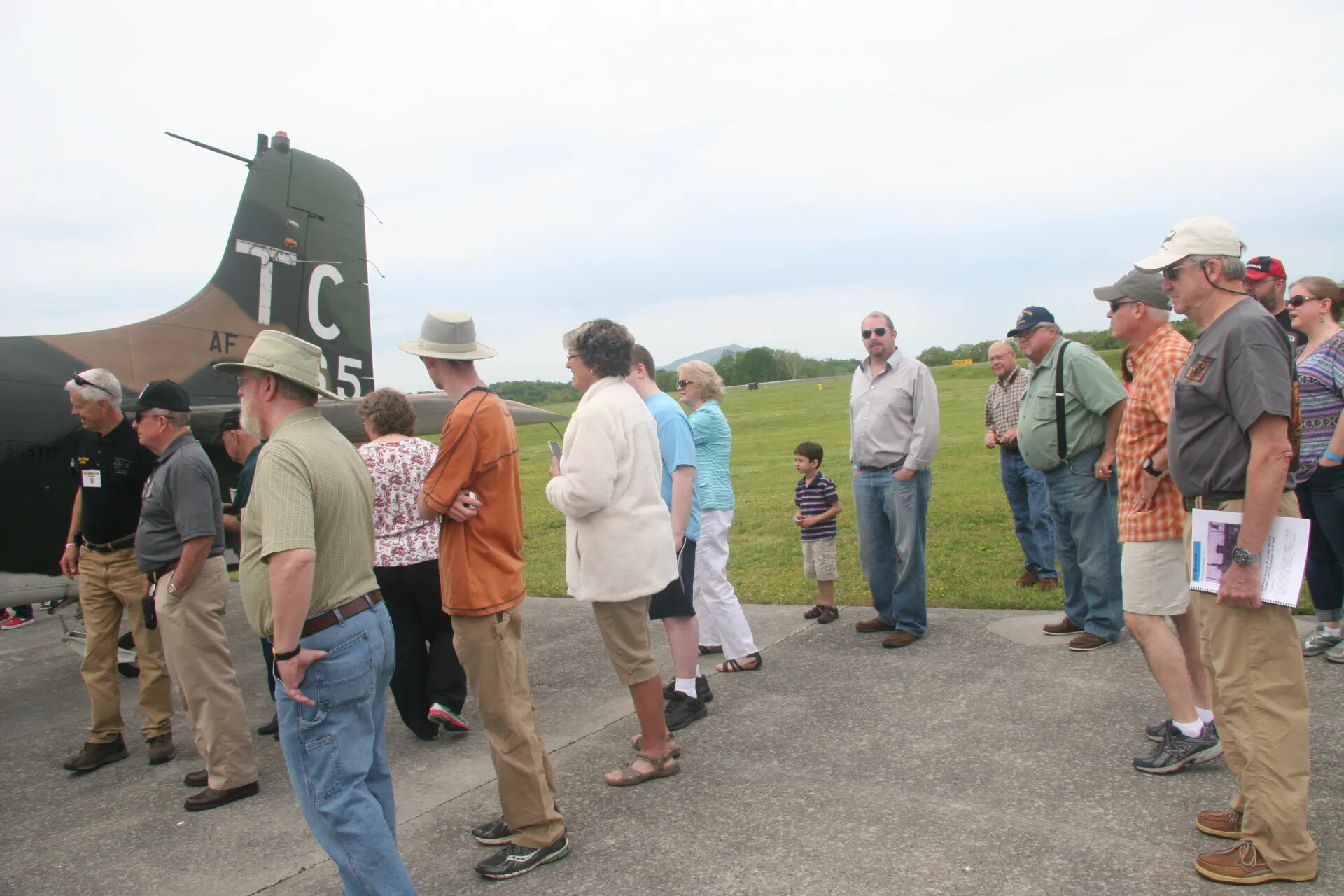Attendees Gather Beside Military Transport Aircraft Tail (Tail Code 'TC'), Operation Tailwind Reunion Event, 2016