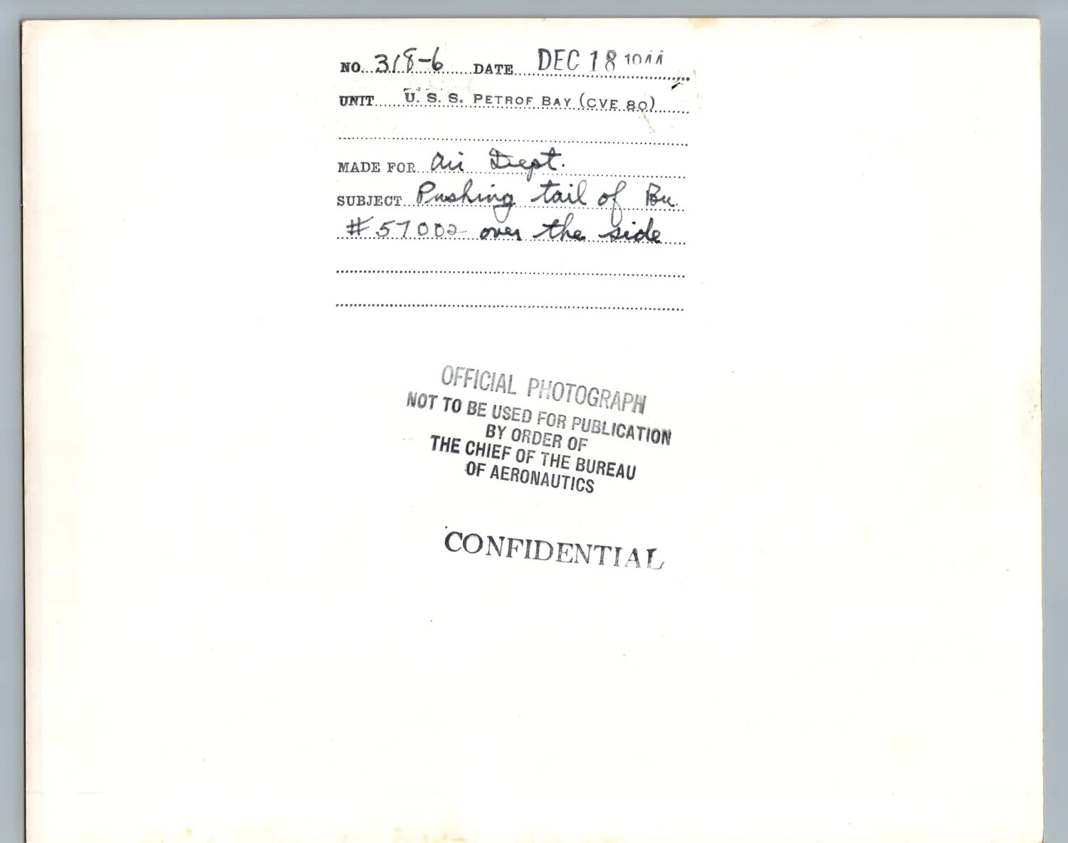 Caption Card, U.S.S. Petrof Bay (CVE-80), 18 December 1944 - Jettisoning Aircraft Bu. No. 57002