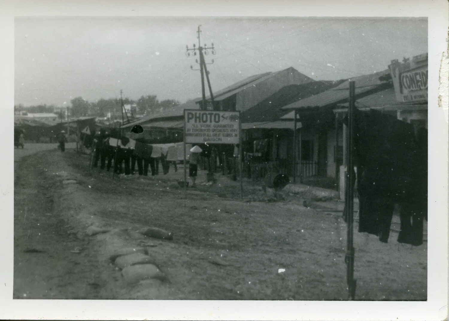 Street Scene with Photo Service Shop and Sandbagged Position, South Vietnam, 1967