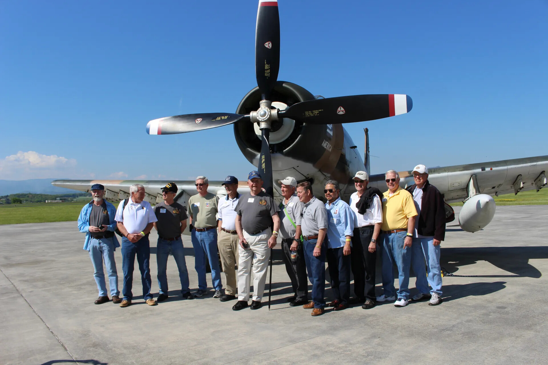 Group Portrait Beneath A-1 Skyraider Propeller (Alternate Frame)