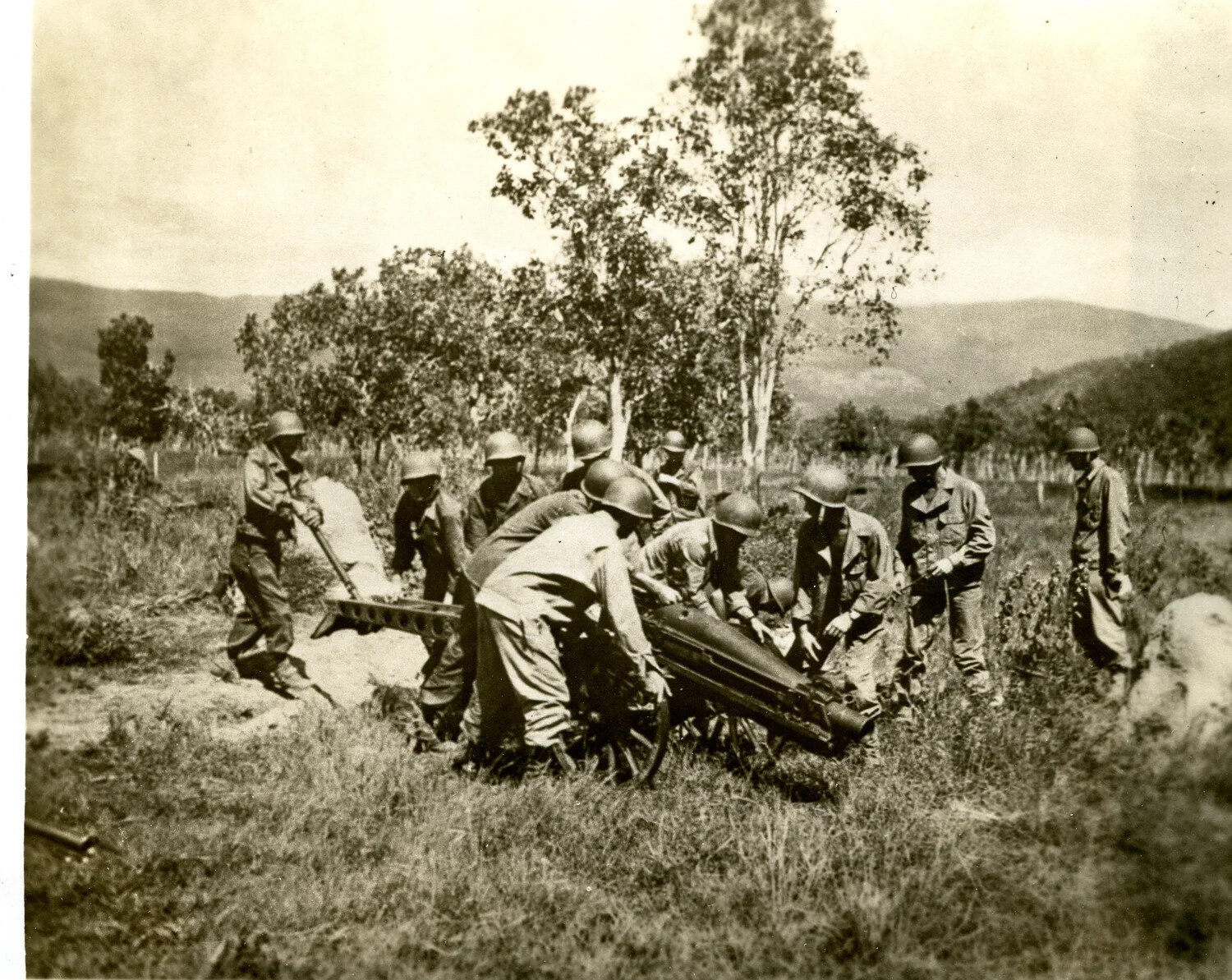 U.S. Army Gun Crew Maneuvering a Light Field Gun in Open Terrain, WWII