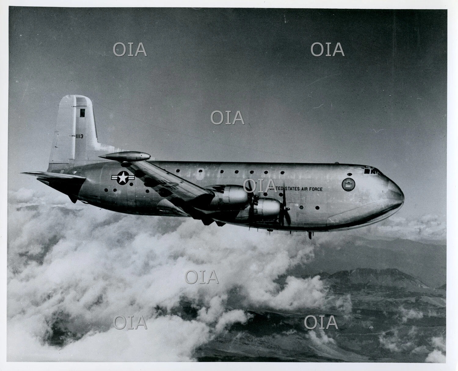 Douglas C-124 Globemaster II (Tail No. 1113), U.S. Air Force, in Flight Above Clouds and Mountains