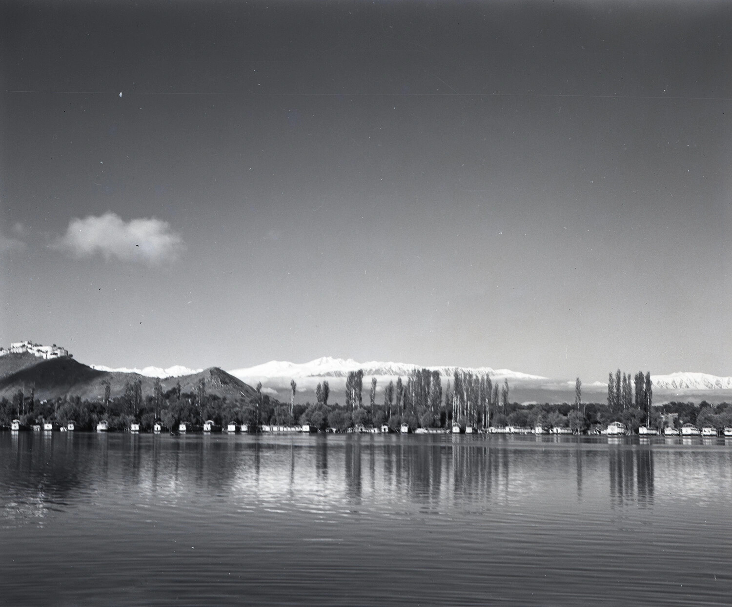 Scenic View of a Kashmir Lake with Houseboats and Hill Fort, Srinagar Vicinity, India