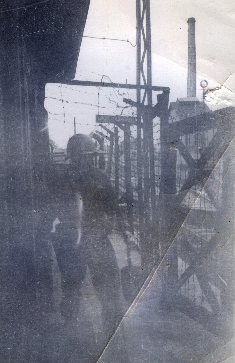 American Soldier at Barbed-Wire Compound with Russian-Language Signage, End of War in Europe, 1945