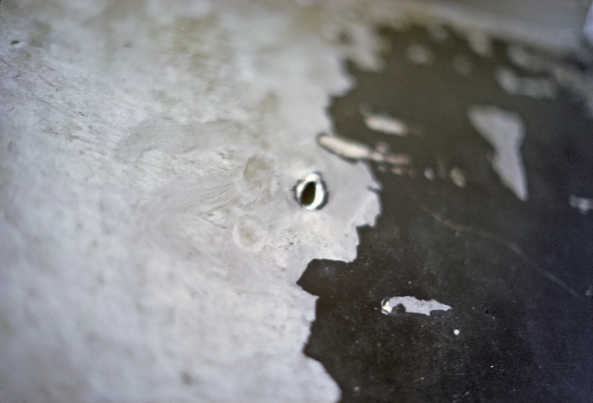 Close-Up of Battle Damage Puncture and Torn Skin on Aircraft Surface, Vietnam War Era